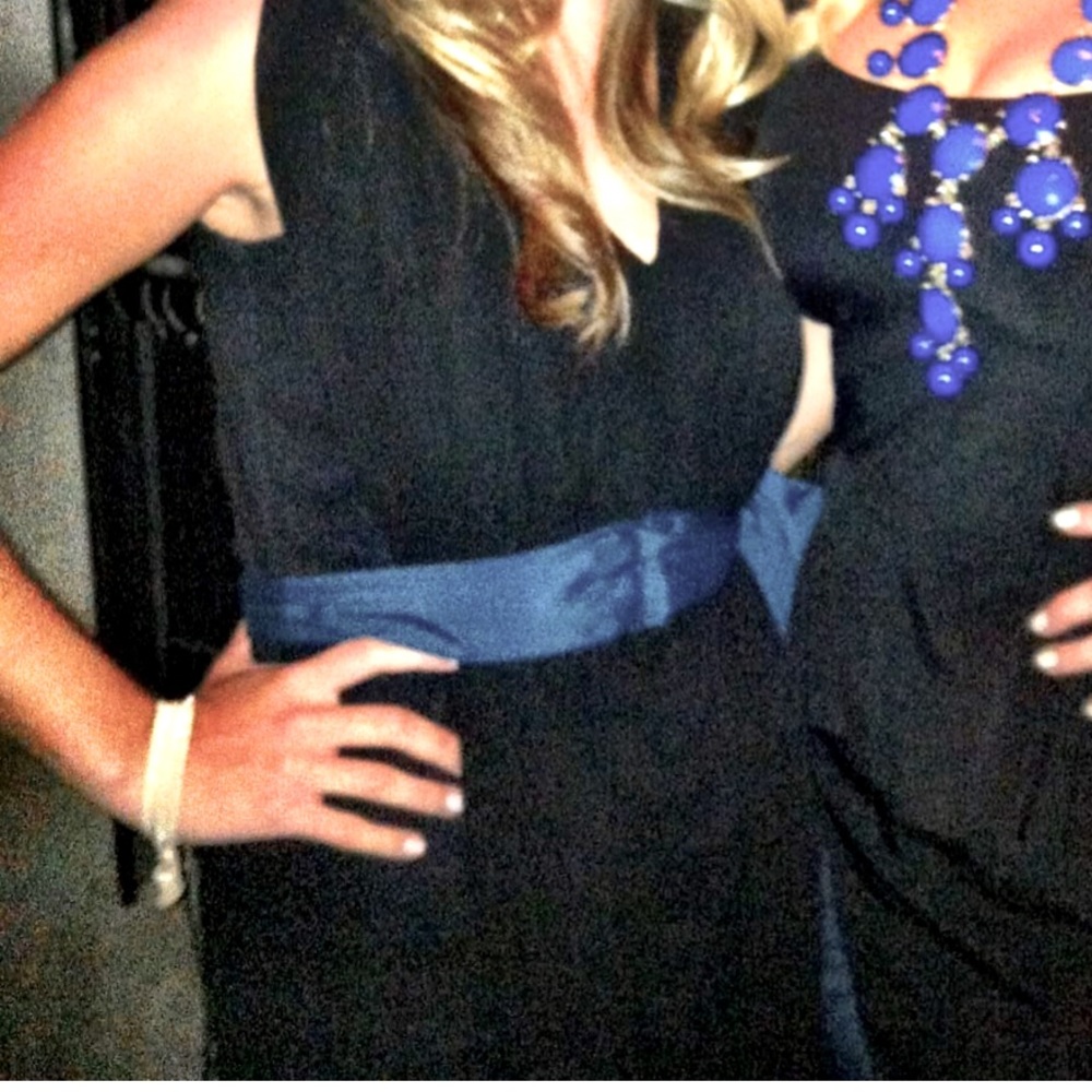 Black dress with blue tie accent.